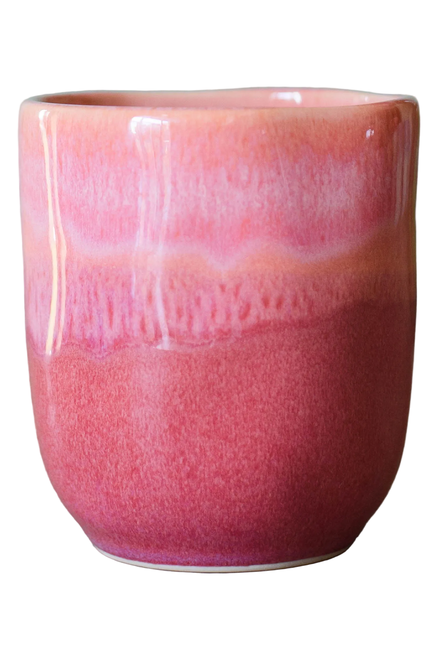detailfoto van handgemaakte keramieken mok zonder oor in kleur roze oranje kleurverloop